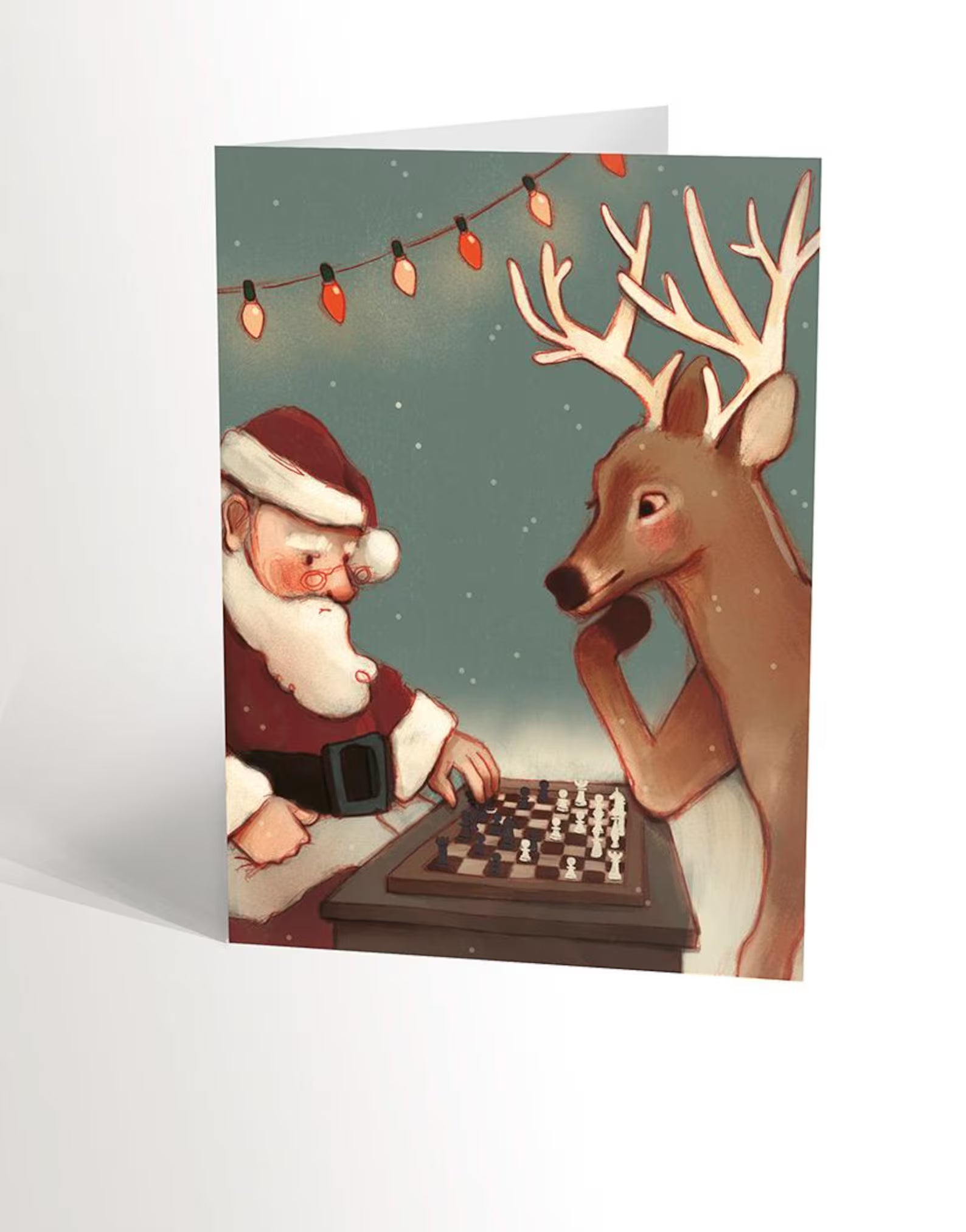 Carte de souhaits Père Noël jouant aux échecs avec un renne - Valérie Boivin Illustrations